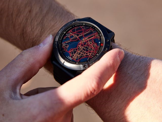 a man wearing a smart watch and checking the digital map